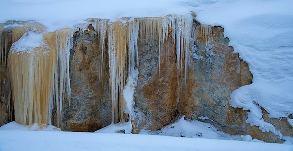 Melting spring waters soon become colorful icicles.