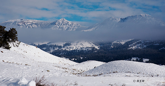 Mountains, clouds and snow along the road to Mammoth from Lamar Valley.